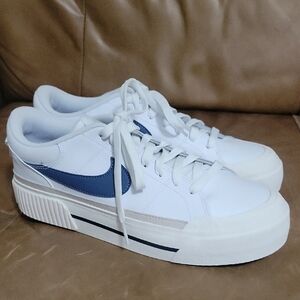White Sneakers with Blue Swoosh
